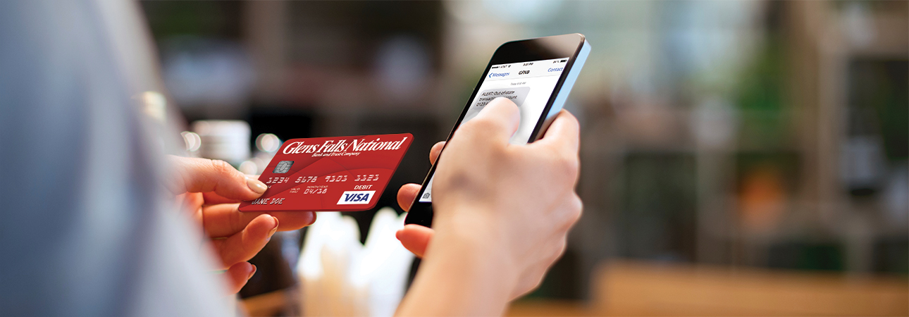 man holding phone and credit card